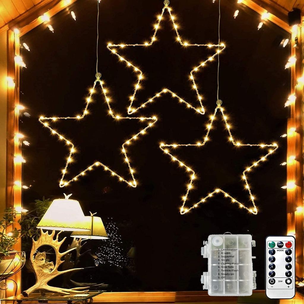 LED Christmas stars in a window with battery box and remote