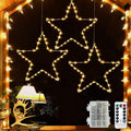 LED Christmas stars in a window with battery box and remote